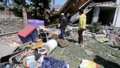 The image displays people near the debris of the house of Lashkar-e-Taiba terrorist Jameel Ahmed, that was demolished amid a crackdown on the terror ecosystem in the aftermath of the Pahalgam terror attack in Bandipora district of J&K on Sunday April 27, 2025