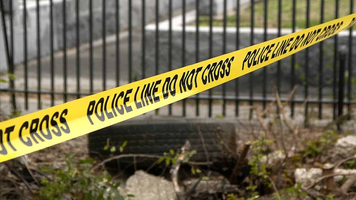 Yellow police tape reading 'Police Line Do Not Cross' at an accident scene - represents investigation into fatal hit-and-run involving Indian student in US.