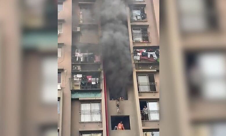 Woman dangles child from balcony as fire engulfs Ahmedabad building