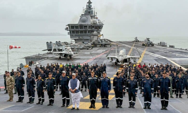 In this handout image released on May 30, 2025, Union Defence Minister Rajnath Singh with Chief of the Naval Staff (CNS) Admiral Dinesh K Tripathi and others aboard aircraft carrier INS Vikrant. (Handout via PTI Photo)