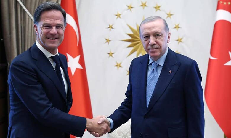 Turkish President Recep Tayyip Erdogan (right) shakes hands with NATO Secretary General Mark Rutte