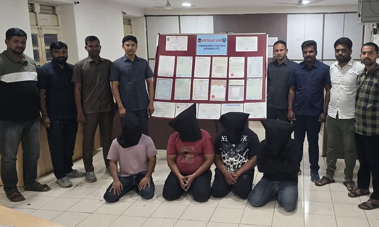 Four individuals, with black cloth bags over their heads, are kneeling in the foreground, indicating their arrest by the Hyderabad police on Tuesday, May 13, for their alleged involvement in a fake educational certificate racket.