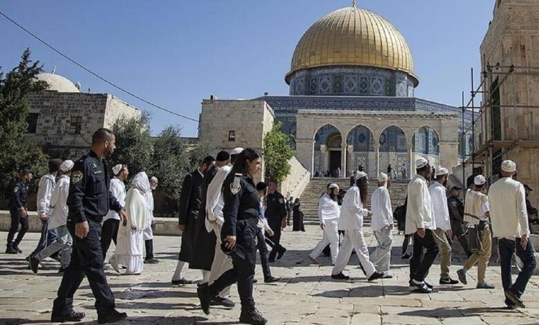 Israeli settlers escorted by police walk through Al Aqsa Mosque compound in occupied East Jerusalem.