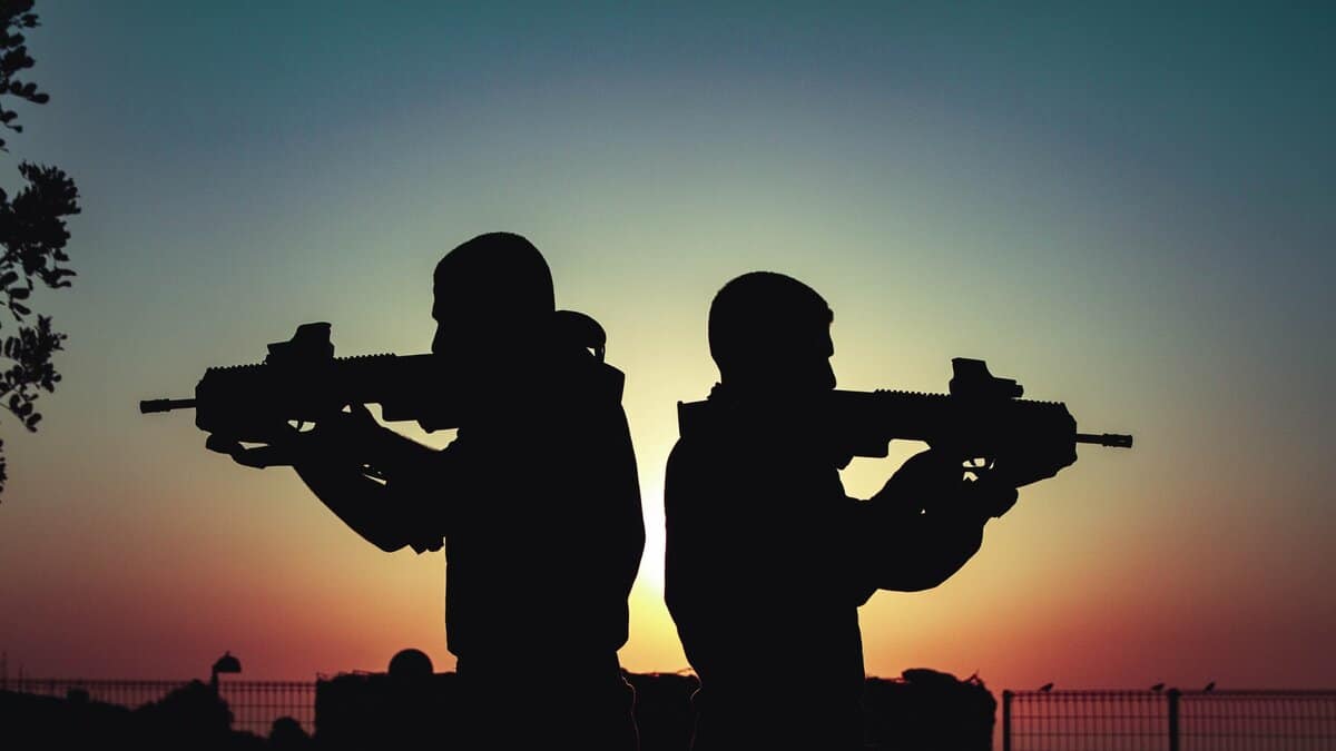 Representational Image of two men facing opposite sites holding guns