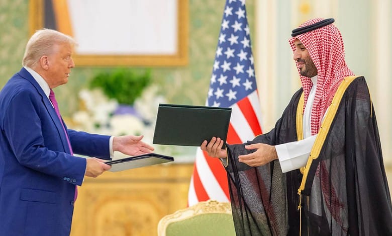 Former US President Donald Trump exchanges documents with Saudi Crown Prince Mohammed bin Salman during a formal meeting in Riyadh, Saudi Arabia.
