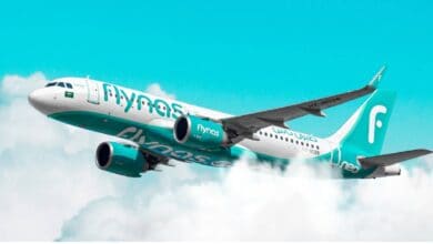 Flynas aircraft in flight above the clouds – Saudi Arabian budget airline.
