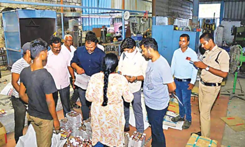 A group of people standing around in a factory