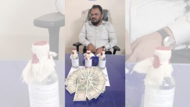 TGSPDCL Assistant Engineer sits at a desk with ₹10,000 bribe money laid out in front of him, moments after being caught red-handed by Telangana ACB officials in Pragathinagar.