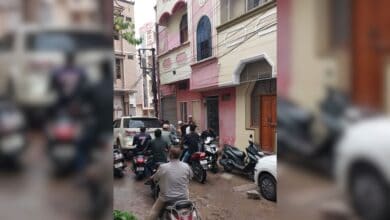 Bikes and cars pass through the narrow lanes of Jangammet colony
