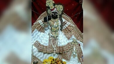 The image displays a picture of Lord Krishna from Vrindavan's Banke Bihari temple