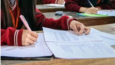 A representational image of a person writing an exam