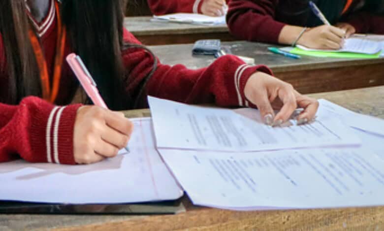 A representational image of a person writing an exam