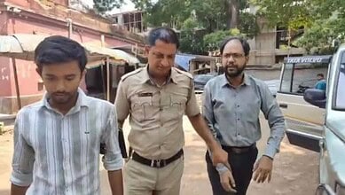 The image displays a picture of two Hindu men arrested for creating communal tension in West Bengal