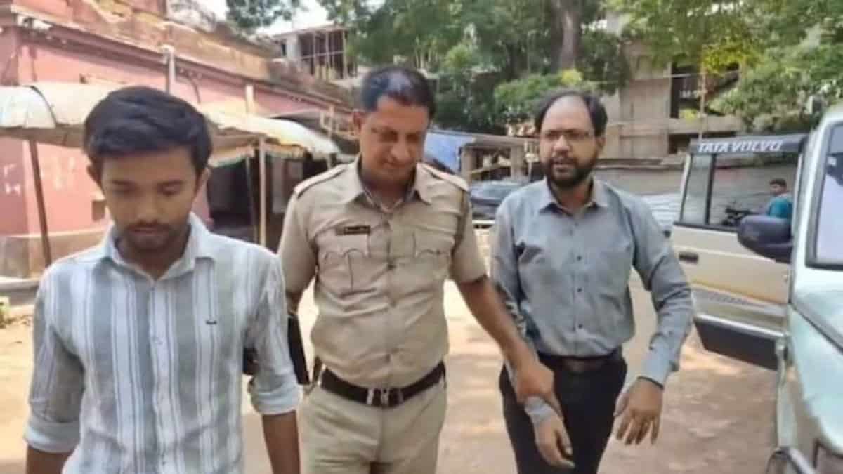 The image displays a picture of two Hindu men arrested for creating communal tension in West Bengal