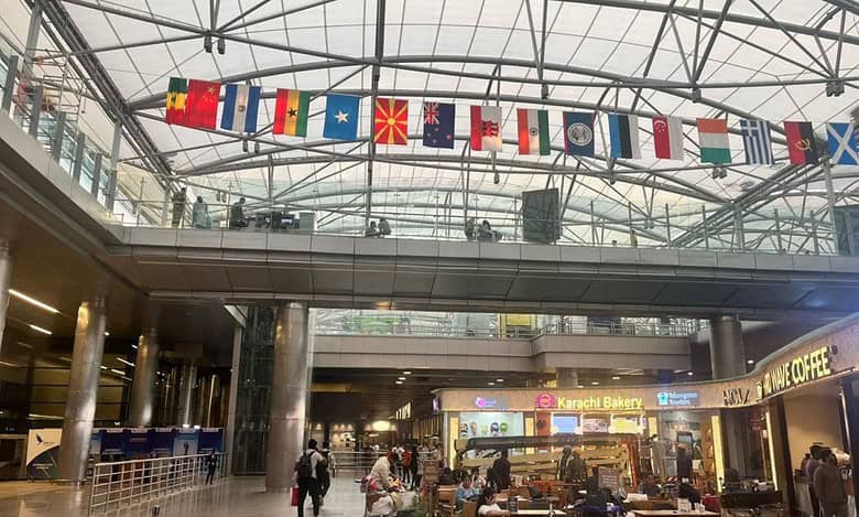 Flags of countries to be represented at Miss World 2025 are displayed at Hyderabad Airport ahead of the pageant