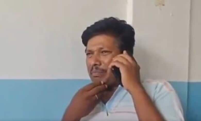 A man speaks to the police on the phone after the stillbirth of his twin children in Ibrahimpatnam on Sunday, May 4