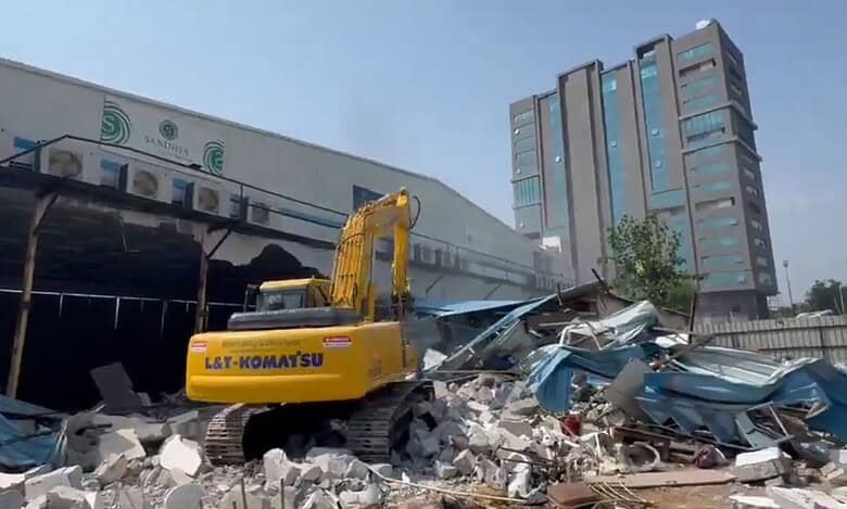 A buldozer demolishes Sandhya Convention in Gachibowli on Tuesday, May 6
