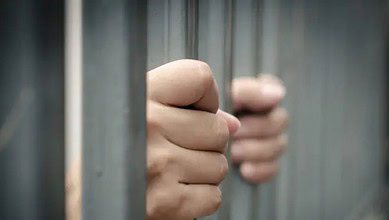 A representational image of a person in jail