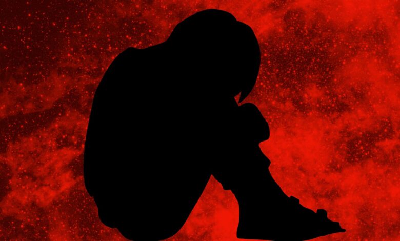 The image displays a silhouette of a boy with a red background