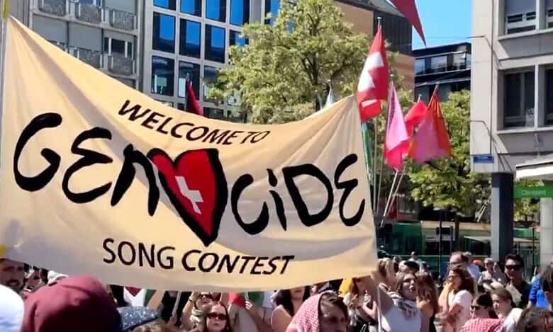 Pro-Palestine protestors hold a banner against Israel at Eurovision 2025