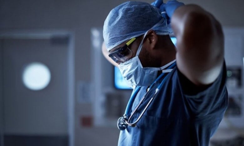 The image shows a picture of a doctor ready to conduct a surgery