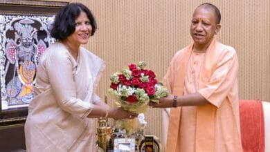 The image displays a picture of AMU vice chancellor Naima Khatoon with UP chief minister Yogi Adityanath