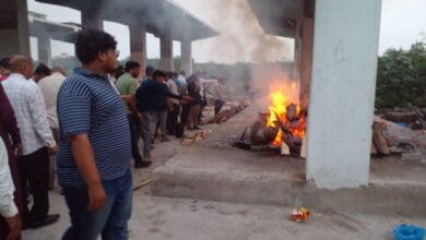 The image displays a funeral scene