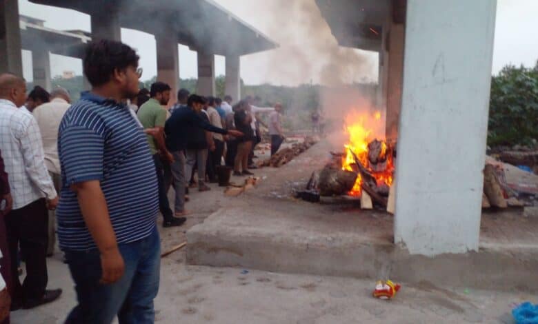 The image displays a funeral scene