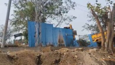 A bulldozer demolishes a make-shift shelter in Hydernagar