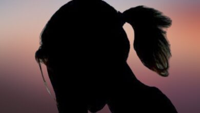 The image displays a silhouette of a girl with a reddish background