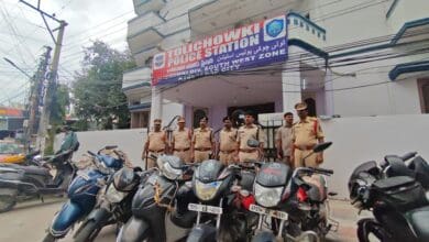 Police officials pose with recovered vehicles