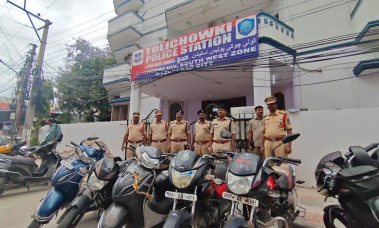 Police officials pose with recovered vehicles