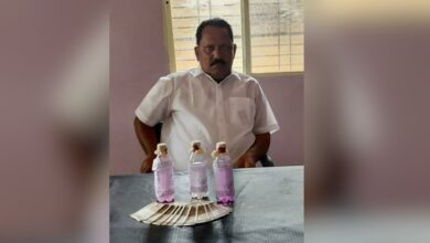 The image displays a picture of Nirmal government officer caught for bribery by Telangana ACB