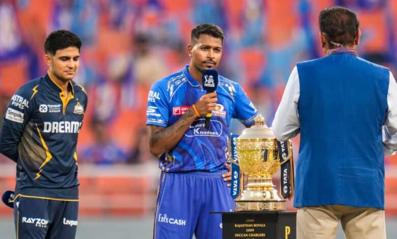The image displays a toss between captains of Mumbai Indians and Gujarat Titans in IPL 2025