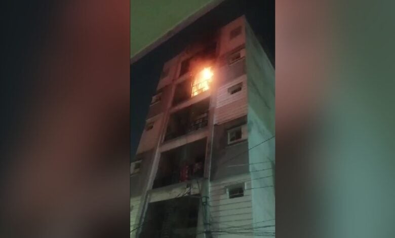 The image displays a picture of a building on fire in Hyderabad