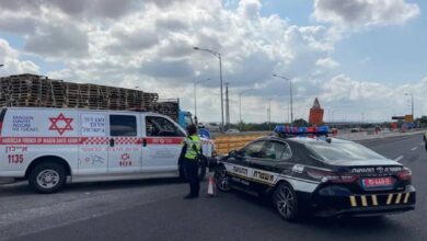 Israeli police and emergency services block a road near Ben Gurion Airport following a missile strike.
