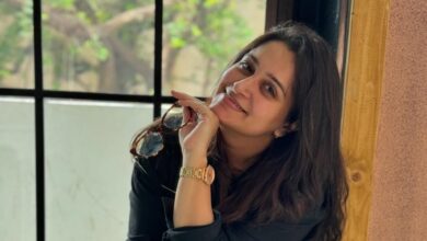 Dipika Kakar sitting next to a window, holding her eye glasses