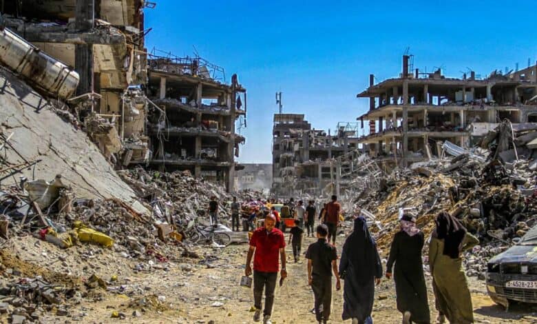 Civilians walk through rubble and destroyed buildings in Gaza after Israeli airstrikes, showing the humanitarian impact and devastation of conflict.