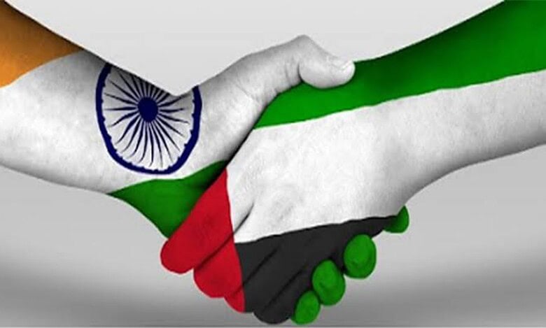 Handshake with India and UAE flags symbolizing strong bilateral relations.