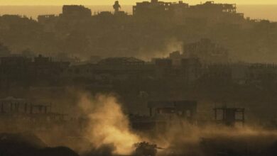 "An Israeli army tank kicks up dust as it manoeuvres in the Gaza Strip, seen from southern Israel at sunset on May 4.