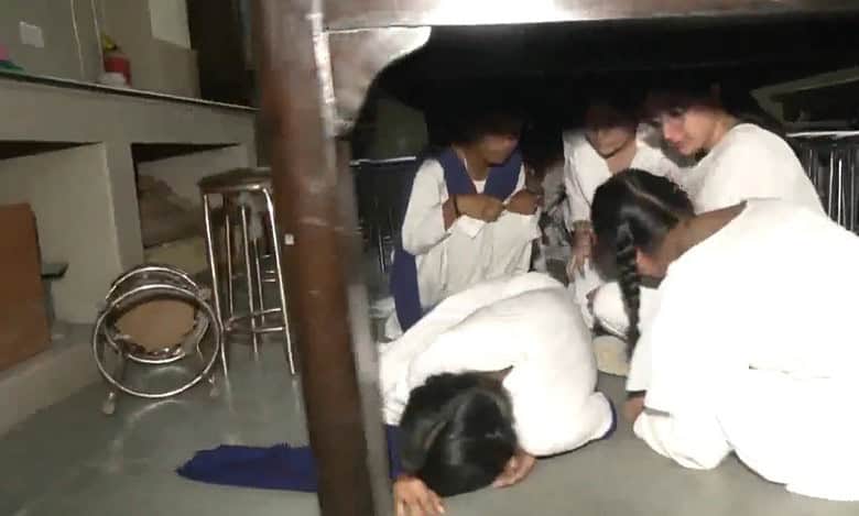Students take shelter under the table as part of mock drill in Jammu