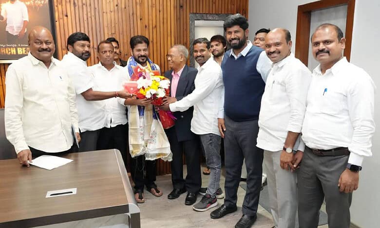 Members of the newly formed NRI Advisory Committee present a bouquet and shawl to Telangana Chief Minister A Revanth Reddy during a courtesy visit at his residence in Hyderabad on May 5.