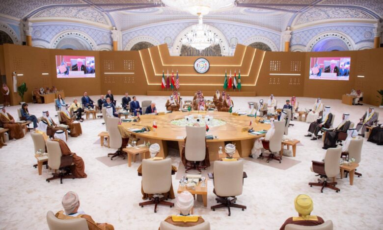 President Donald Trump attends a high-level Gulf Cooperation Council (GCC) summit in Riyadh, Saudi Arabia, alongside Gulf leaders and dignitaries. The ornate hall features flags of GCC member states and the United States, with a central roundtable discussion focused on regional security and Iran.