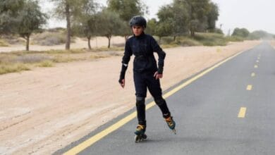 Zayne Merzi Sodawaterwala inline skating alone on a smooth track at Al Qudra, wearing full protective gear and a focused expression.
