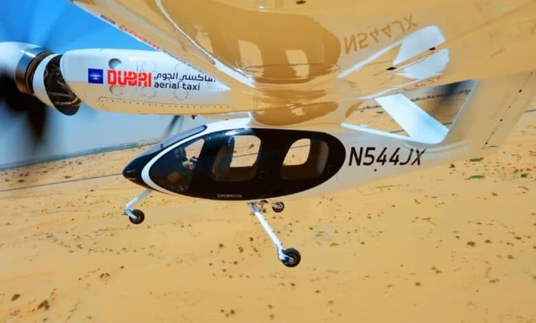 The image of a Joby Aviation’s electric aerial taxi with Dubai government branding seen mid-flight over a desert landscape during its first successful test.