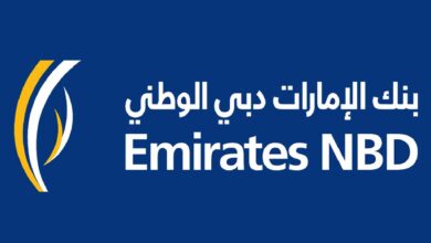 The image of a logo featuring the text "Emirates NBD" in white on a blue background, with Arabic text above and a stylised yellow and white design on the left.