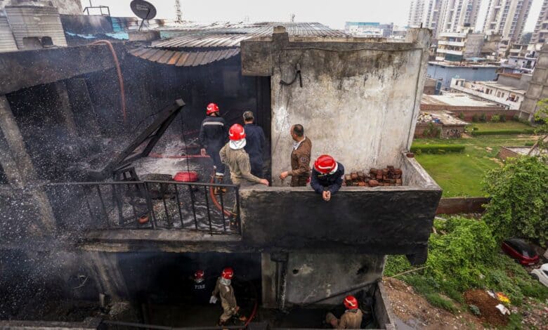 _Firefighters carry a victim's body after a fire broke out in a chemical factory