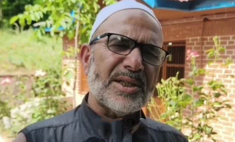 Image of Gulzar Hussain speaking to local media