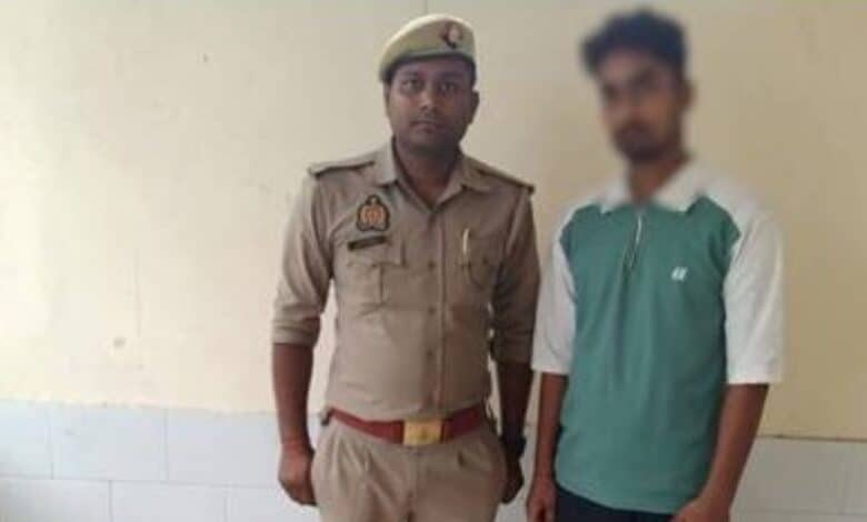 Image of the accused standing with Jaipur police official after being arrested for raping two minors.