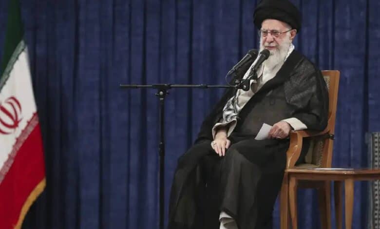 The image of a Iran’s supreme leader Ayatollah Ali Khamenei while delivering a televised address seated next to the national flag.
